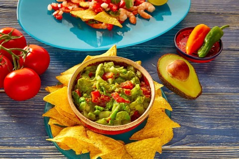 Guacamole with avocado tomatoes and nachos mexican food