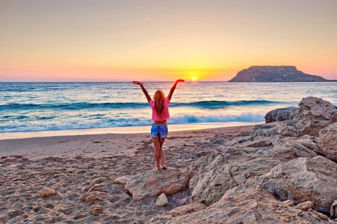A woman at sunset in Fragolimnionas beach of Karpathos, Greece, Europe