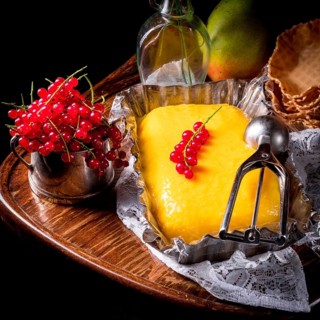 Homemade mango ice cream with currant