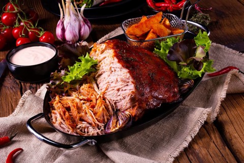 Delicious pulled pork with jacket potato quarters