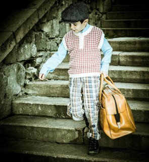 Exterior stairs and child with vintage bag. Vintage clothes style