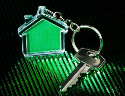 Keychain figure of house and key close up