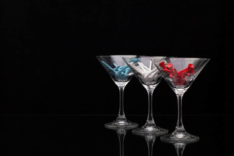 Three glasses of champagne with golf tees