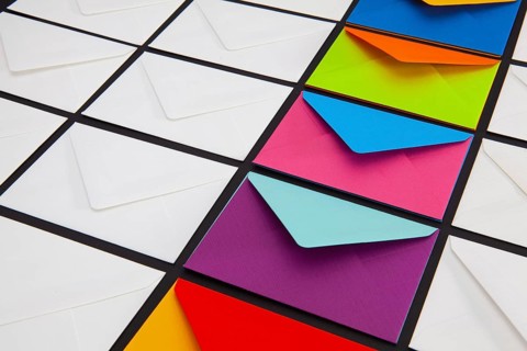 Composition with white and colored envelopes on the table. The photo suitable for various holidays