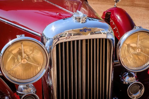 Lisbon, Portugal - Sep 29, 2024: Close view of front grille, headlights and hood of vintage red
