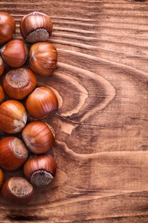 Hazelnuts on vintage wooden board food and drink concept