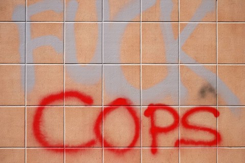 The political slogan Fuck Police on a tiled wall
