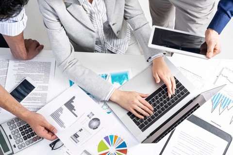 Corporate teamwork concept with businessmen. Secretary working with laptop Office desk with