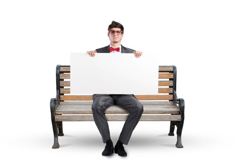 Young businessman holds a large white banner. sits on the bench