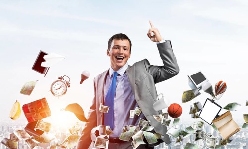 Young businessman and falling from sky various goods and cash. Handsome man in business suit and