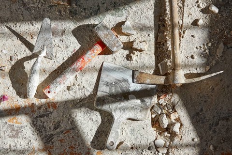 Mason tools on debris background in house improvement construction