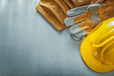 Tool belt safety gloves building helmet on concrete background