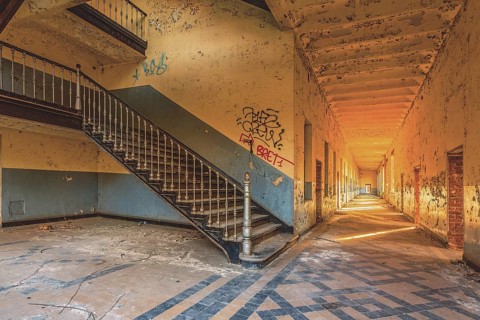 A long, deserted corridor with stairs and graffiti on the walls, Prison H11, Lost Place, Verviers,