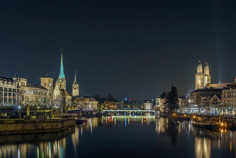 Limmat river with view of churchs in Zurich in evening, Switzerland, Europe