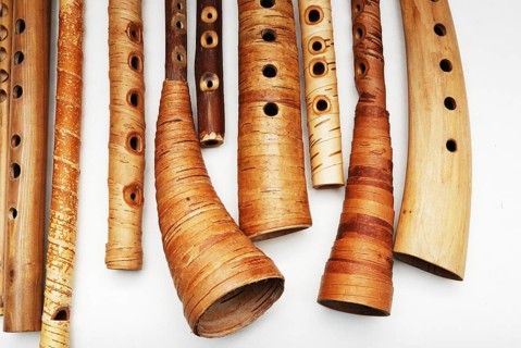 Ancient woodwind folk instruments on a white