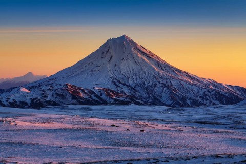 Stunning winter mountain landscape of Kamchatka Peninsula, beautiful morning snow capped cone of