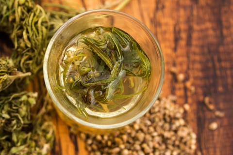 Cannabis herbal tea on wooden background