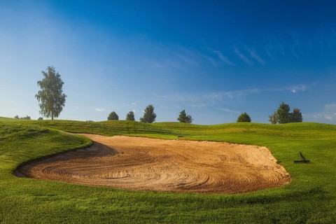 Summer golf course in the morning mist
