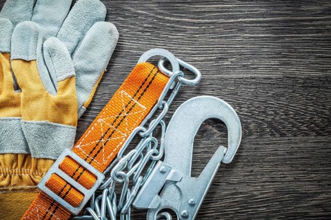 Construction gloves safety strap on wooden board