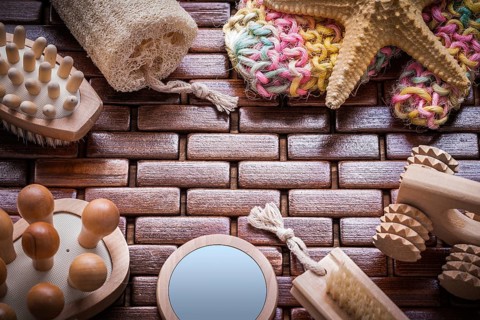 Loofah handglass massagers peeling brushes starfish and colorful bath sponge on textured wooden