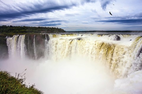 Grandiose waterfalls Iguazu in the rainy season - the Devil's Throat. Over the rumbling waterfall