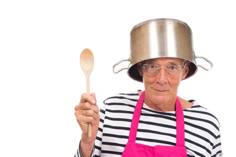 Senior houseman with pink apron and cooking pot isolated over white background