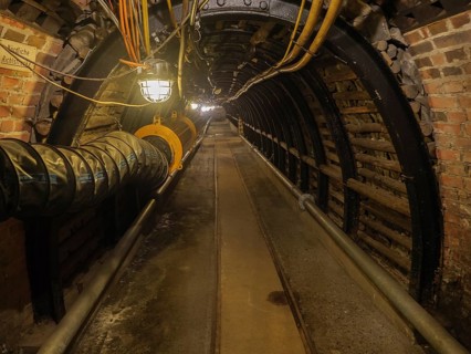 Dark industrial tunnel with brick walls and visible lighting, Bochum, North Rhine-Westphalia,