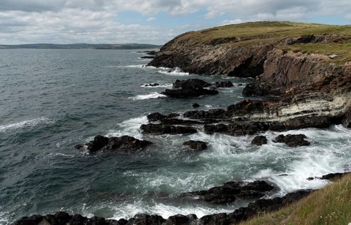 Rocky coastal area with windy waves crashing on the rocks. Atlantic Ocean. Baltimore beacon area
