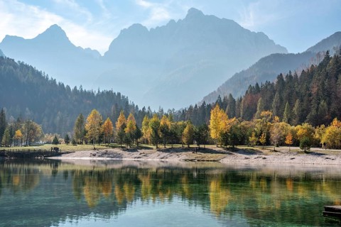 Scenic autumn forest at Crystal Lake in the Julian Alps, Slovenia, Europe