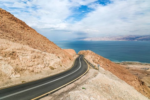 Gorgeous paved road along the seashore. The most salty sea on earth - Dead Sea. The Judean Desert