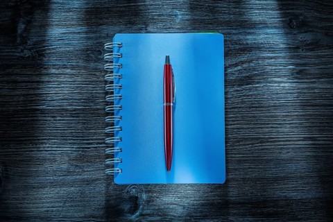 Set of notebooks pen on vintage wooden board
