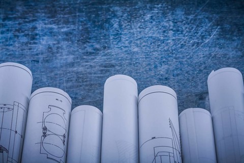 Scratched shiny metallic background with composition of blueprints construction concept