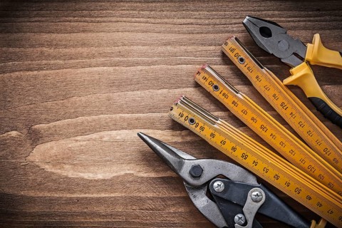 Set of steel cutter pliers wooden meter construction concept