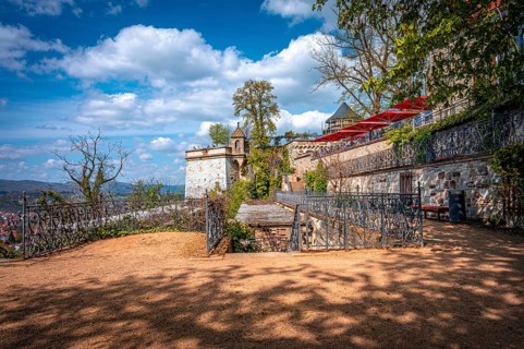 Quiet area next to a castle wall with a view of the countryside under a sunny sky, Wernigerode,