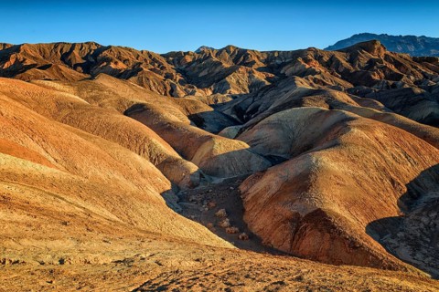 Zabriskie Point, sunrise, sun, golden path raod composed of sediments from Furnace Creek Lake,
