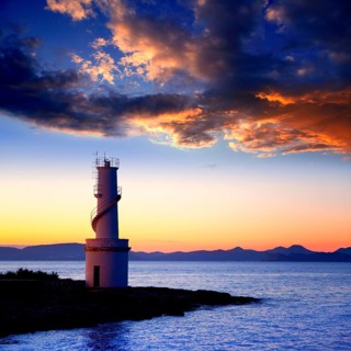Ibiza island sunset of Es Vedra and La Savina lighthouse in Formentera