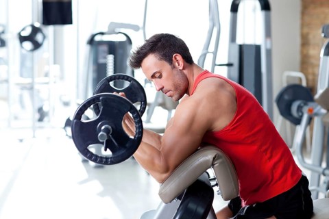 Man with weight training equipment on sport gym club