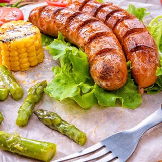 Grilled krakauer sausage with boiled corn and green salad