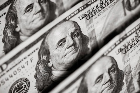 Hundred dollars bills standing in a row. Selective focus