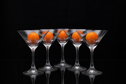 Five glasses of champagne with golf balls