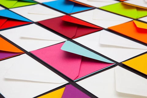 Composition with white and colored envelopes on the table. The photo suitable for various holidays