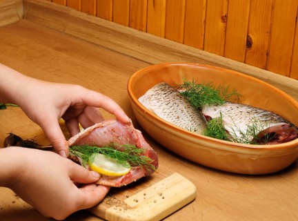Fish carcass with spices on wooden hardboard, prepared for cooking