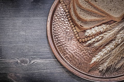 Golden rye wheat ears slices of brown bread vintage brass tray food and drink concept