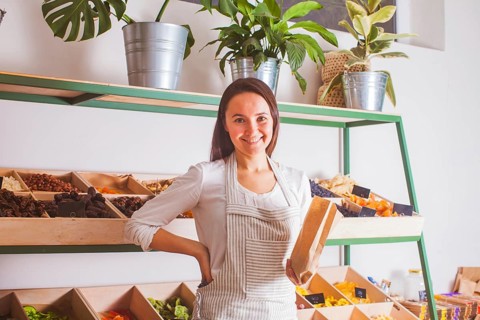 Portrait of woman seller in the grocery shop. Zero waste and raw food concept