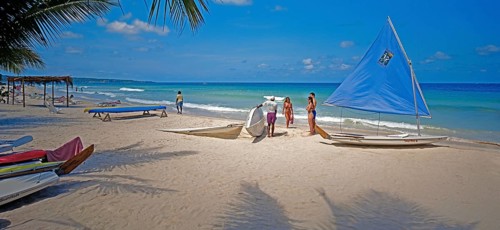 Beach, sailing boats, beach holidaymakers, water sports enthusiasts, Negril, Jamaica, Caribbean,