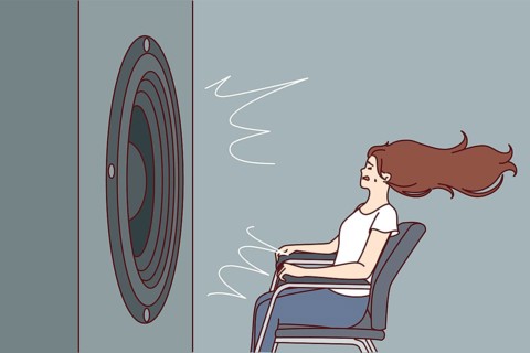 Deafened woman near giant subwoofer from music center listening to loud rhythmic track with bass