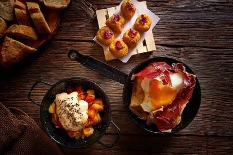 Tapas of Spain broken eggs Croquettes and Bravas potatoes