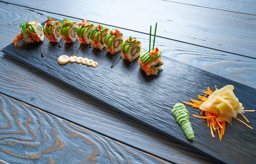 Dragon shape Sushi rice roll with nori prawn avocado sesame and teriyaki