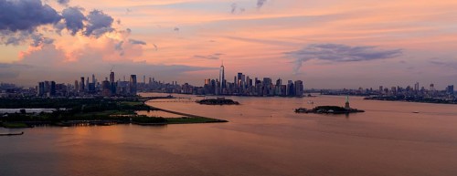 Three cities can be seen in this view of Hudson Bay at dusk with the Statue of Liberty Visable