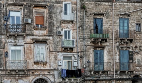 Taranto, Italy, 30 November, 2023: shabby chic derelict buildings with laundry hanging from the